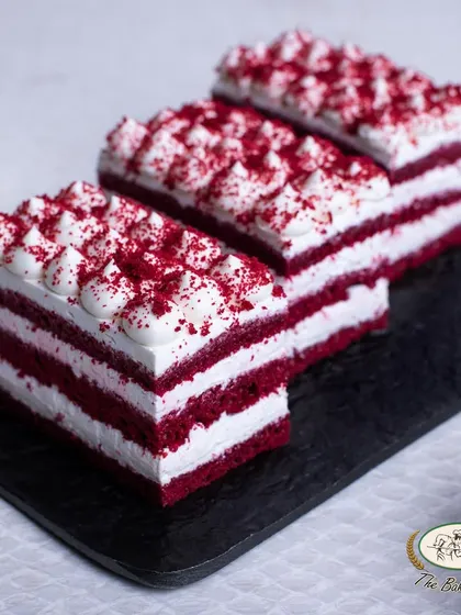 A closer look at our layered Red Velvet Pastry, showing the perfect ratio of cake to cream cheese frosting.