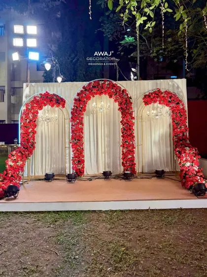 A wide shot of the red rose photo booth in its outdoor setting.