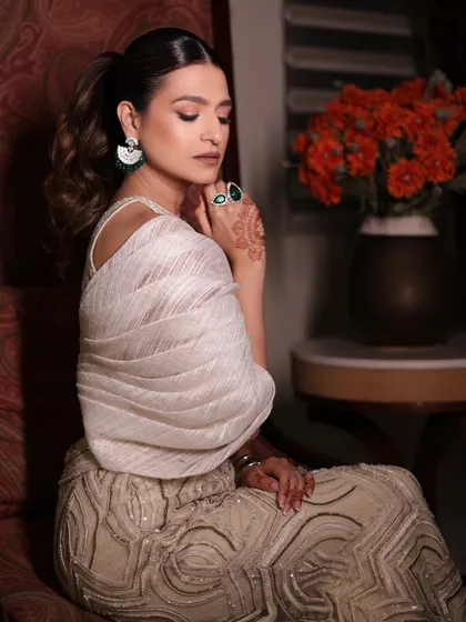 A close-up of the client's poised look in the ivory sharara set, a truly timeless and captivating style.