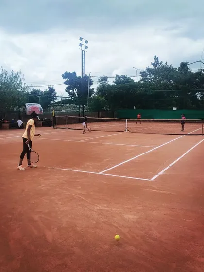 Players competing across multiple courts during the Tennis360 TS7 AITA U-14 tournament in Bangalore.