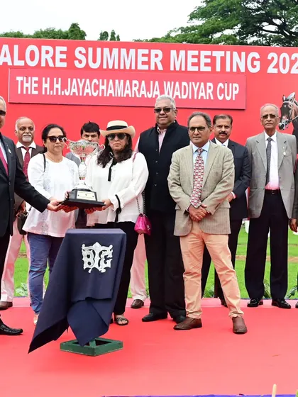 Mr. Chaduranga Kanthraj Urs presents The H.H. Jayachamaraja Wadiyar Cup to the winning connections of Meropi.