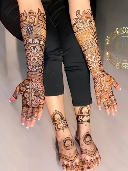 A complete bridal mehandi set, with intricate designs on the hands and matching patterns on the feet. The lotus motif on the feet is a popular and elegant choice.