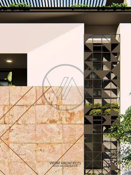A detailed view of the Dasharatha residence facade. This shot focuses on the junction between the etched stone panel and the custom-designed geometric metal screen, highlighting the project's craftsmanship.