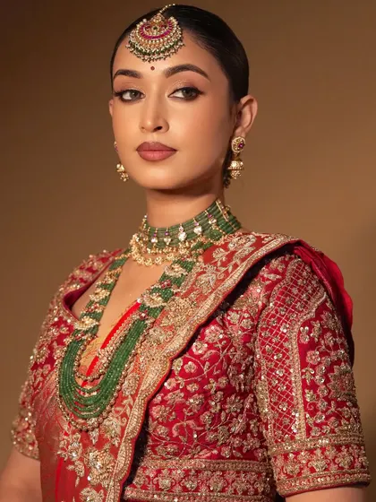 A smiling portrait of the model. The makeup is radiant and flawless, proving that glam can also look fresh and modern.