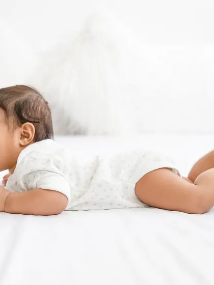 Giggles and wiggles on a clean white bed. Sometimes the simplest setups create the most joyful and authentic baby photos.