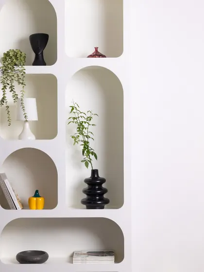 This wider shot of the arched shelving unit emphasizes its clean, geometric forms and its potential as a minimalist backdrop for product or portrait photography.