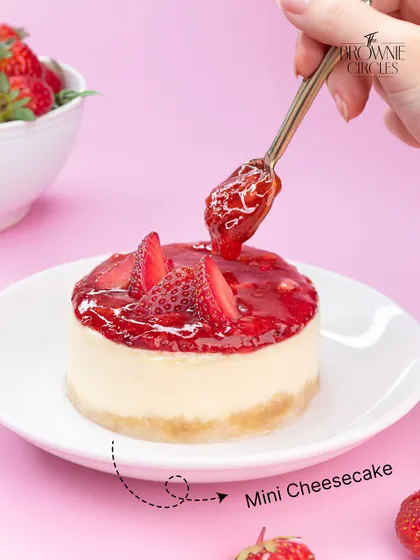 A beautiful mini strawberry cheesecake, perfect for a single serving of indulgence. The creamy cheesecake is topped with a fresh strawberry compote.