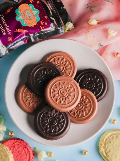 A plate of our assorted chocolate-coated biscuits, a simple yet delicious treat for Diwali. The biscuits are coated in both milk and dark chocolate for variety.