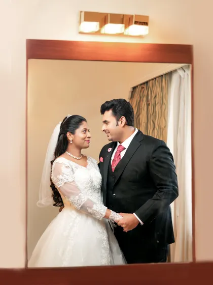 A sweet mirror portrait of a couple on their wedding day, capturing their reflection and their love.