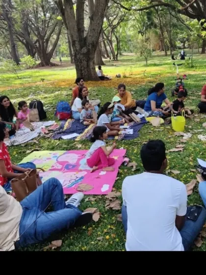 Another view of our story time group, spread out on picnic blankets. It highlights the casual, community-focused nature of our events.