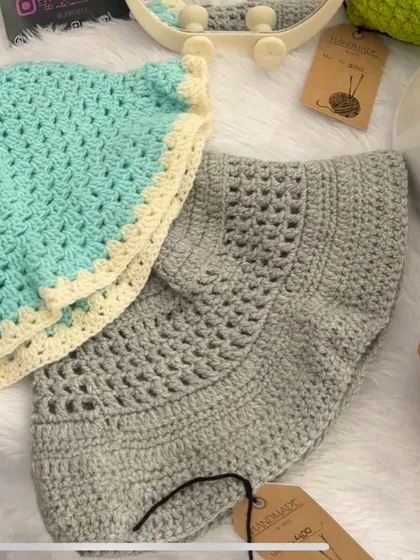 Here are two of my crochet bucket hats side-by-side. One is a solid grey and the other is a lovely sea green with a cream-colored trim, showing some of the color options available.