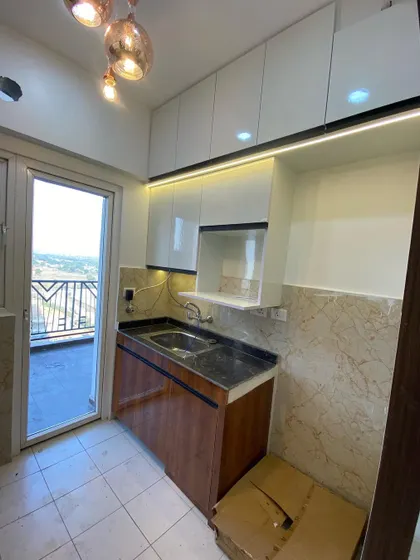 The sink and utility area of the kitchen, with a large window that brings in natural light.