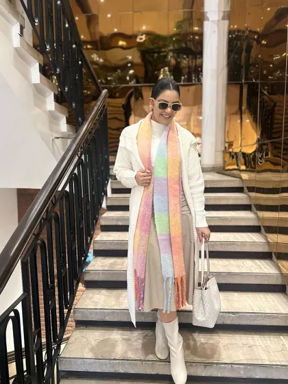Descending a staircase in my layered winter white look. The long lines of the cardigan and dress create an elegant silhouette.