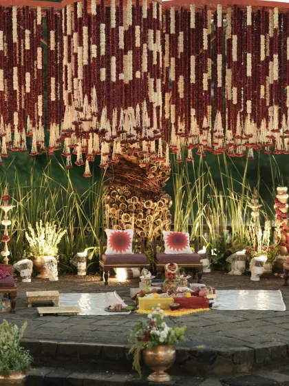 The complete setup of the Banaras Ghat mandap, showing the central stage, ritual area, and the stunning overhead floral installation that defines the space.