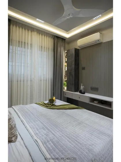 A view of the master bedroom in the Duplex Project, showing the clean lines and sophisticated grey palette. The design focuses on creating a tranquil and uncluttered space.