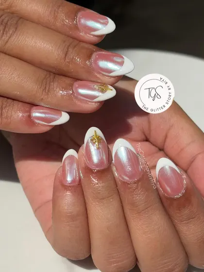 An elegant and trendy "glazed donut" French manicure. The nails have a pearly chrome finish over a sheer base, with clean white tips and a delicate gold charm accent.