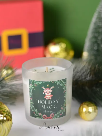 The 'Holiday Magic' jar candle, featuring a cheerful reindeer and a refreshing bergamot and eucalyptus scent to brighten your home.