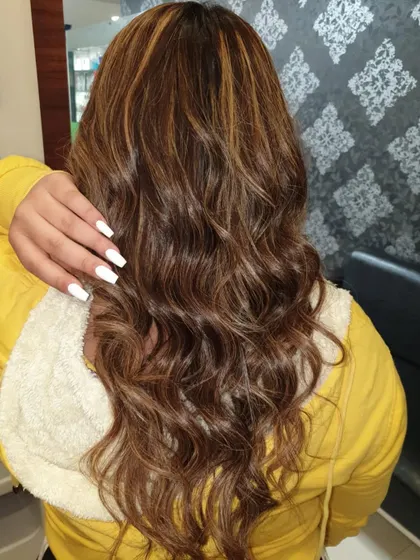A great example of hair coloring and styling. This client wanted rich, natural-looking highlights with soft waves. You can see the dimension in the color and the healthy shine of the hair after the service.