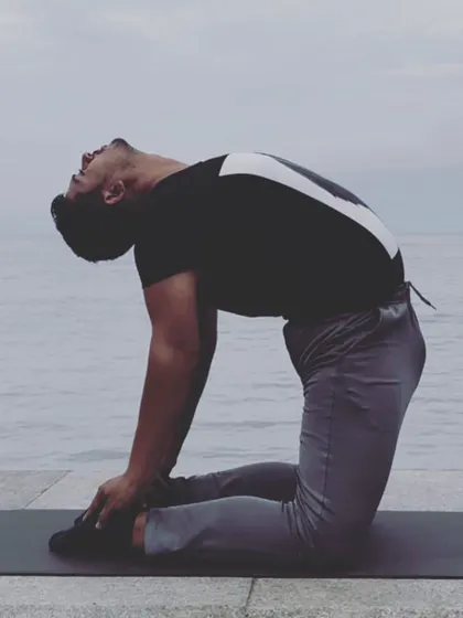 This is Ustrasana, or Camel Pose, performed by the sea. It's a powerful heart opening backbend that stretches the entire front of the body, from the thighs to the throat.