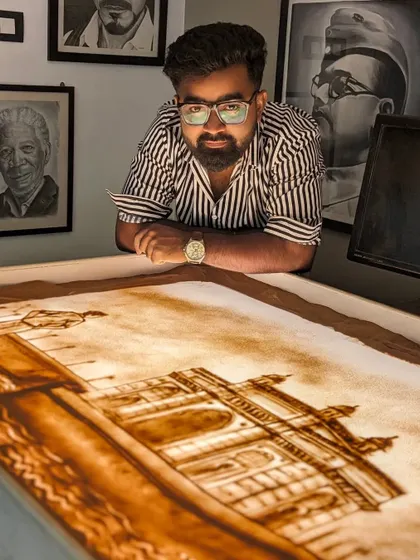 Posing with my finished sand art for the Lodha Group, depicting their founder and one of their iconic buildings.