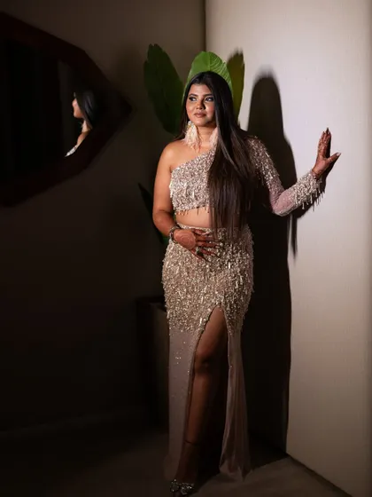 A full length shot showing off her high slit gown. The makeup is sultry and sophisticated.