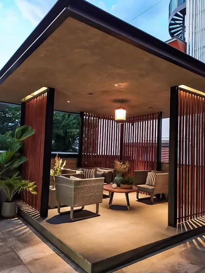 An evening view of the semi-enclosed lounge on the Chhabria's Terrace. The warm overhead and accent lighting creates an inviting and luxurious atmosphere.