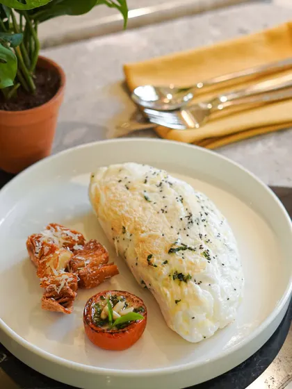 For a lighter but protein-packed option, try our Fluffy White Omelette. Made with organic egg whites, chia seeds, spinach, and parmesan, it's served with roasted tomatoes and potatoes.