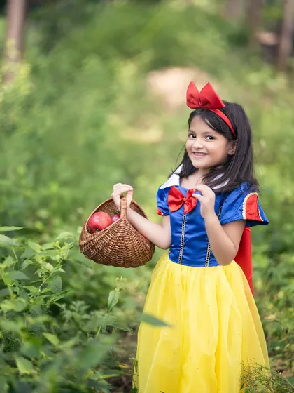 Our little Snow White taking a walk through the woods with her basket of apples. We love finding the perfect outdoor locations to match our fairy tale themes.