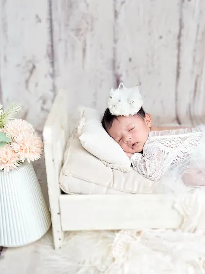 A full view of the tiny princess setup, with the baby sleeping peacefully on a miniature bed. The soft colors and textures make this a truly beautiful image.