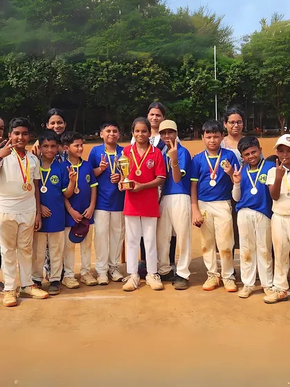 A winning team celebrates with their trophy and medals. These moments of victory are what our players train for, and we are proud to see their efforts rewarded.