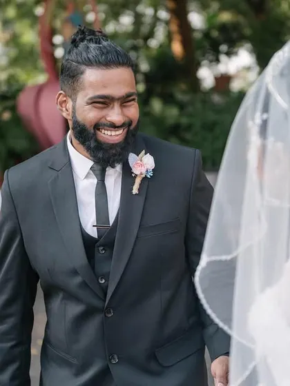 The groom's face lights up with a huge smile as he sees his bride in her wedding dress for the first time. This is the pure, unfiltered reaction I aim to capture.