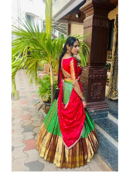 A traditional red and green langa voni, a classic South Indian combination perfect for any auspicious occasion.