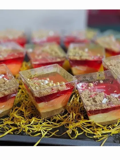 Our beautiful layered custard pudding, a festive dessert that is as delicious as it looks. Topped with jelly and crumble, it's a perfect sweet treat for a Christmas party.