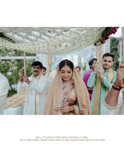 The bride's grand entrance under a floral canopy (phoolon ki chadar) during a beautiful South Indian wedding.