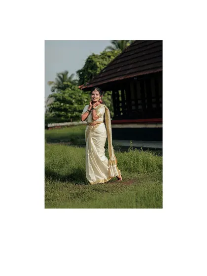 A beautiful full-length portrait of the bride, framed with a simple white border.