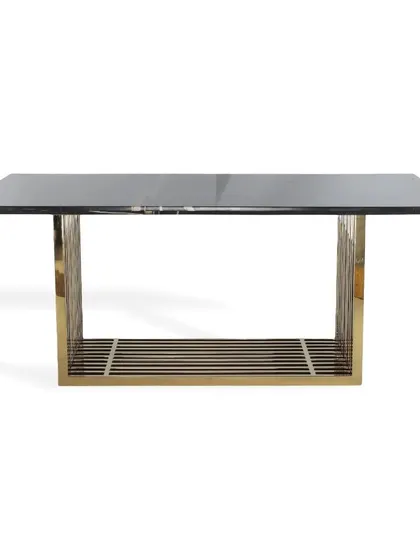 A simple and elegant dining table with a black top and a linear PVD gold base. This versatile design can be styled to fit various contemporary interior themes.