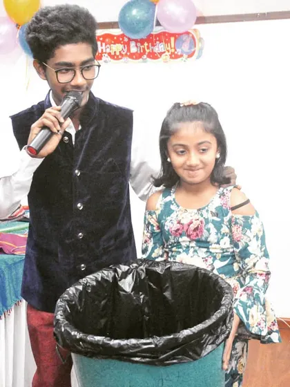 Audience participation is key to my shows. Here, a young volunteer helps me with a trick, creating a fun and interactive experience for her and all her friends at the party.