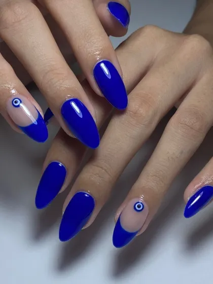 Ward off the bad vibes with this evil eye nail art. A bold cobalt blue is the perfect background for this protective symbol.