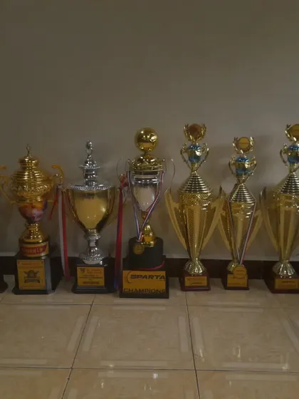 This is our trophy cabinet. Each one represents the sweat, discipline, and hustle my teams have put in to become champions in Mumbai men's football tournaments. We play to win.