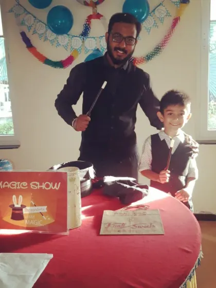 For birthday parties, the birthday kid is the real star. Here I am with my new assistant, ready to make some magic happen together.