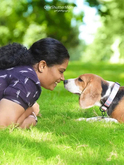 A gentle nose boop between a girl and her beagle. This is a perfect example of the quiet, tender moments that make outdoor pet photography so special.
