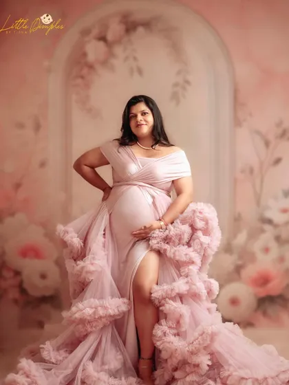 Feeling confident and beautiful in this gorgeous pink gown. The thigh-high slit and ruffled design make it a perfect choice for a glamorous maternity look.