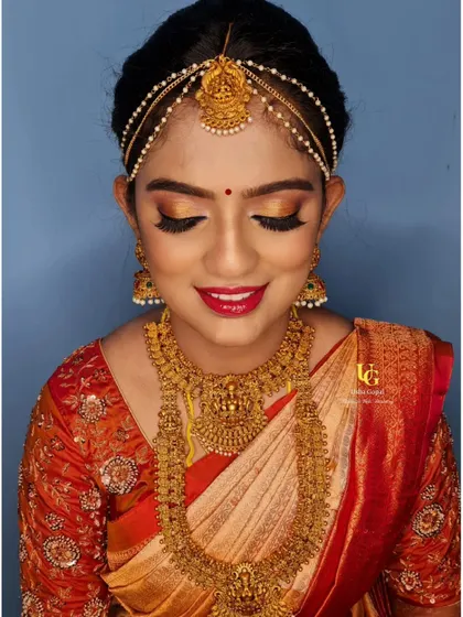 A close-up of Geetha's muhurtham makeup, showing the blended golden eyeshadow and flawless base.