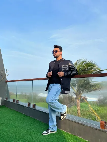 A casual but cool look with a varsity jacket and jeans, perfect for a relaxed party or a day out. My style is versatile and always on point.