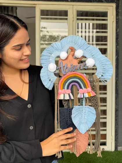 Our personalized name dreamcatchers are one of our most loved products. This piece, featuring a rainbow and cloud design for 'Abizar', shows how we can customize colors and details to create the perfect gift or nursery decor.