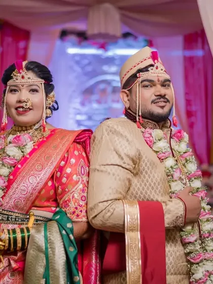 A fun, back-to-back pose from the bride and groom on their wedding day, showing their playful side.