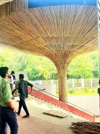 A progressive image from the TAPMI Centre site, with the bamboo cladding being installed on the first parasol. This was a moment where the architectural vision began to take its final form.