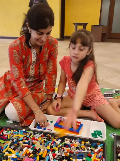 A parent and child work together on a LEGO project. Our workshops encourage family participation, making it a great opportunity for quality time and shared learning.