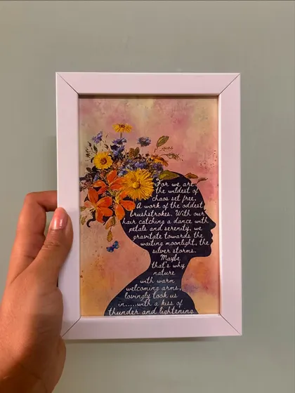 A frame that empowers. This piece features a silhouette filled with a beautiful poem, surrounded by a watercolor floral design, celebrating the strength and wildness of nature.