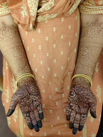 A full view of a developed henna stain on the arms. The color is consistent from the palms to the forearms.